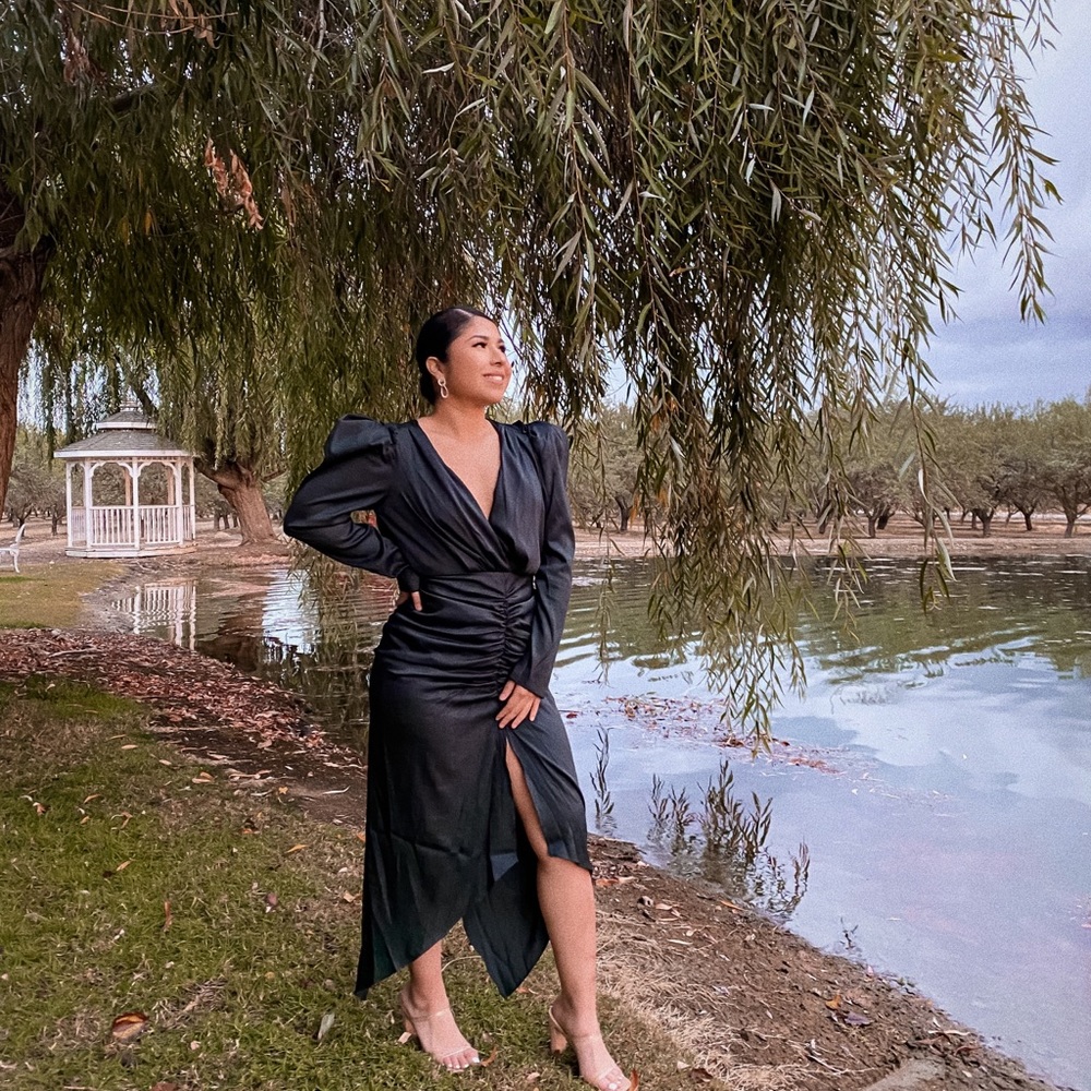 An emerald green, low cut, long sleeve dress.